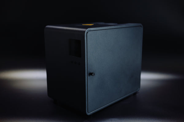 LeBrew PureFluxion P1 smoke purifier in a dark studio, three-quarter view
