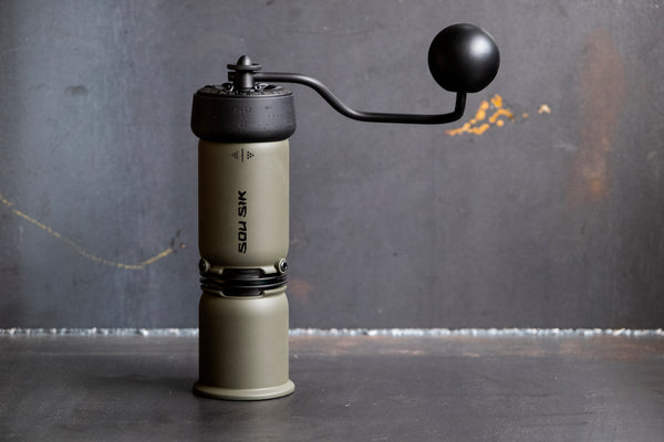 SOU SIK stainless steel manual coffee grinder with LeBrew Burrs 01 system, showing the hand coffee grinder design and burr structure details.
