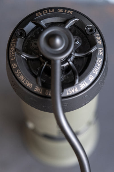 SOU SIK stainless steel manual coffee grinder with LeBrew Burrs 01 system, showing the hand coffee grinder design and burr structure details.
